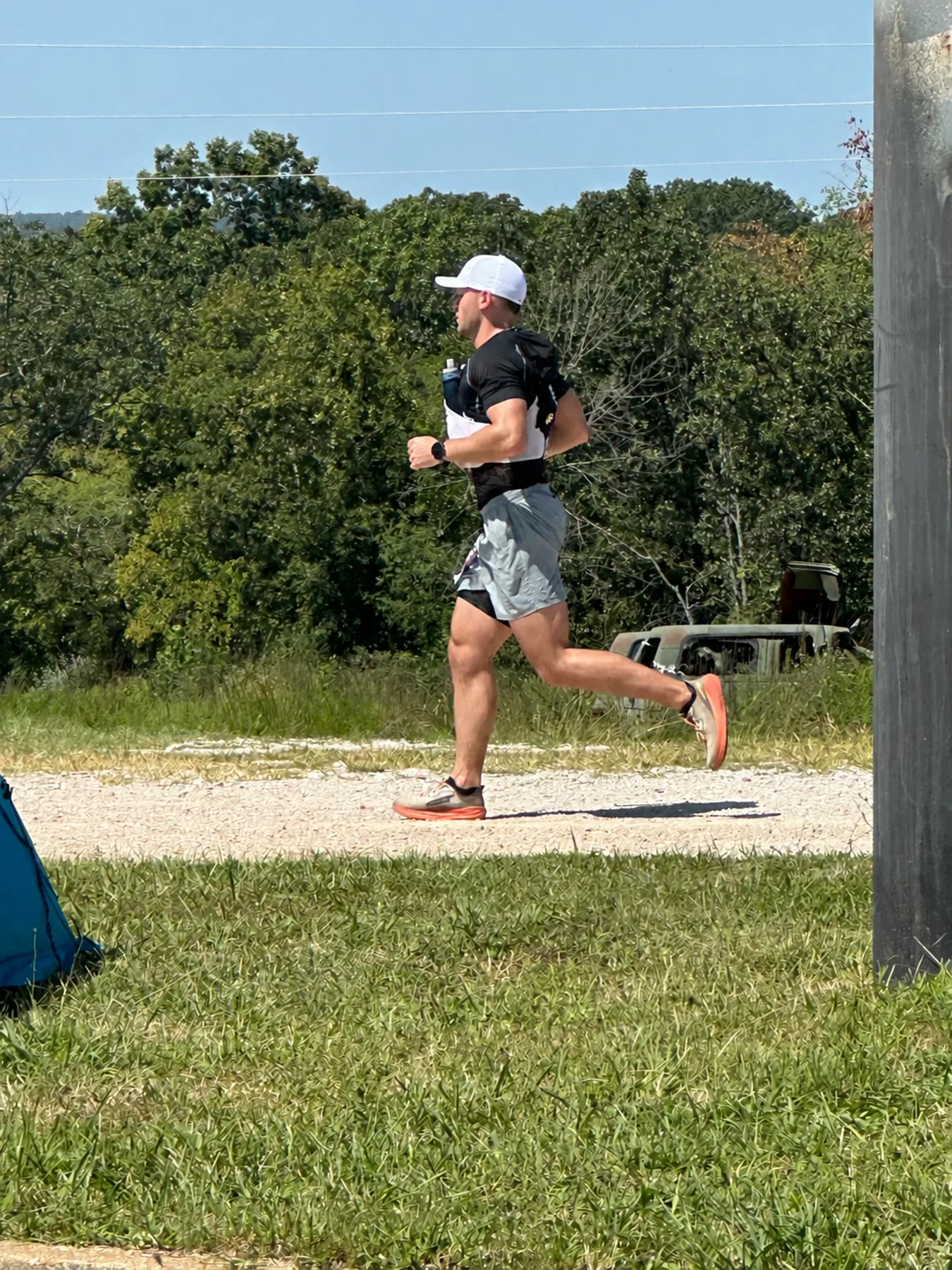 Logan Miller running on a gravel road during a 100-mile ultramarathon
