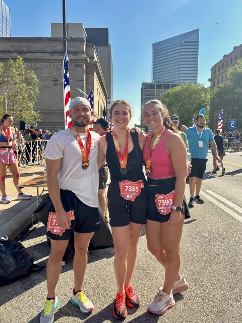 Logan Miller and two fellow runners wearing medals after the 2026 Cleveland Half Marathon