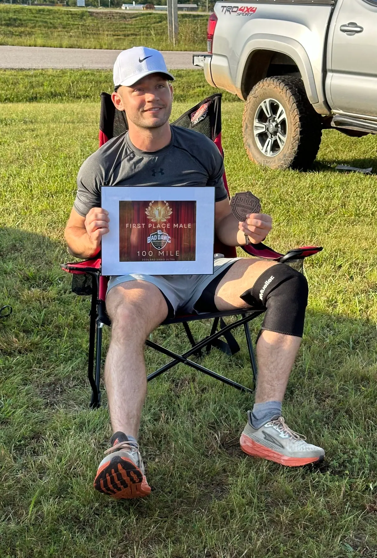 Logan Miller holding his first-place award after a 100-mile ultramarathon